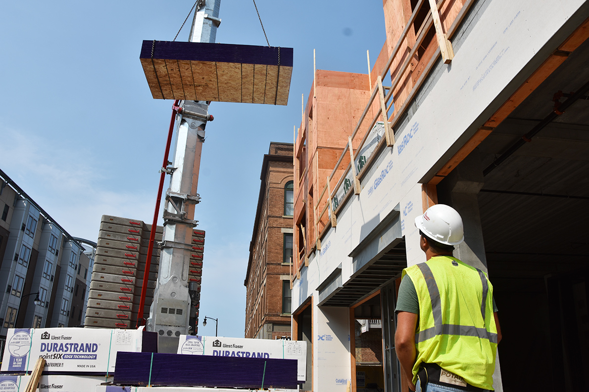 Operator Ted Loegering moves a bundle of plywood with the Potain Hup 40-30 using the remote control.