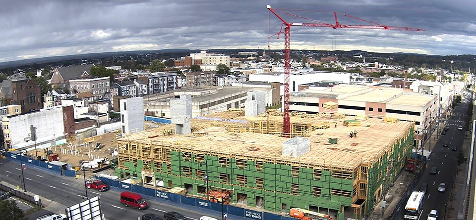 Potain tower crane appears encased inside the courtyard of the complex it is erecting