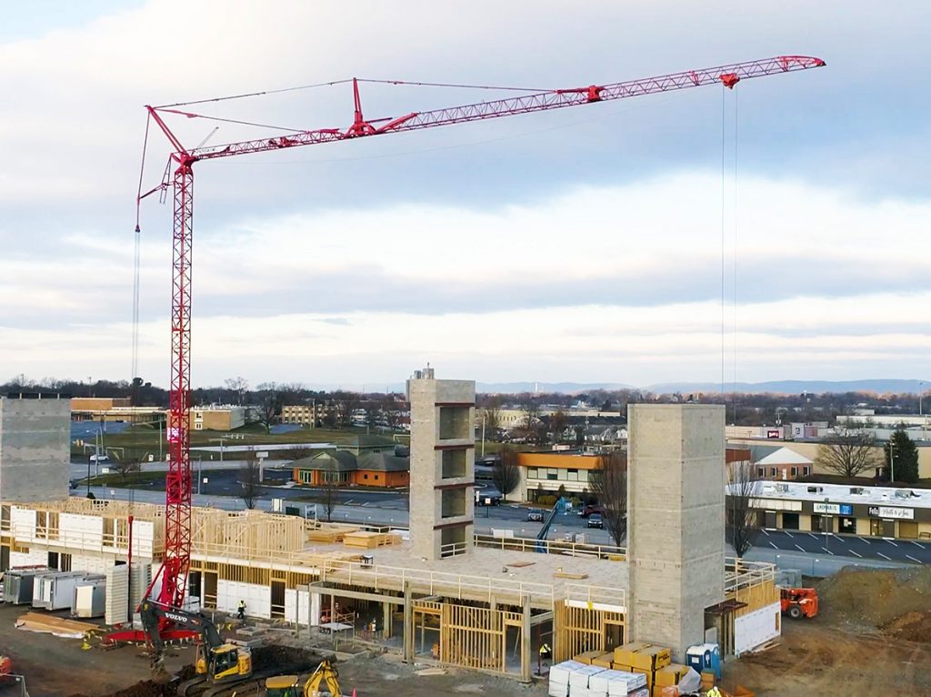 Igo T 85 A self-erecting tower crane on new 5-story hotel jobsite