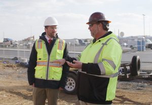 Brent Droege (left), Cedar Run’s financial director, discusses project details with Chad Jacobs, self-erecting tower crane specialist at Potain dealer Stephenson Equipment.