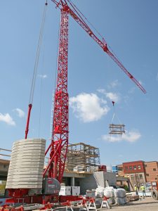Operating a self erecting tower crane to lift a truss